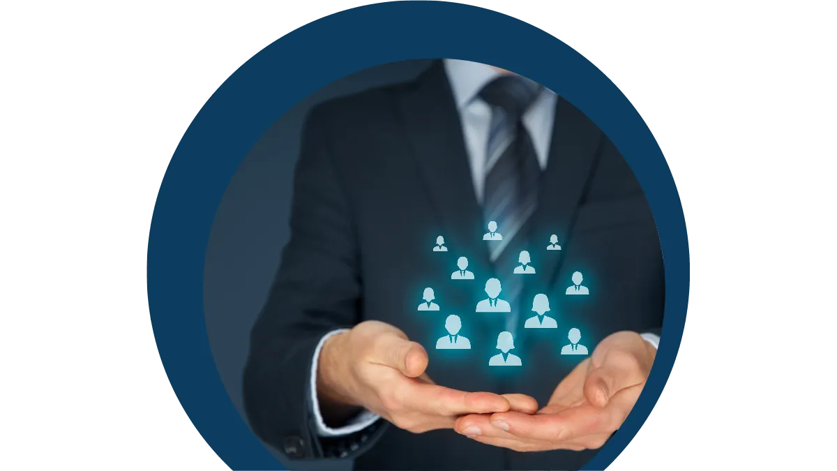 Person in a suit holding a glowing network of people icons in open hands